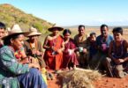 Aboriginal community members engaged in cultural activities outdoors.