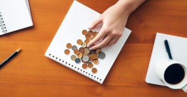 Person counting coins with notebook and coffee in Australia.