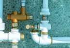 Close-up of swimming pool plumbing system and components.