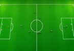 Soccer players on field, strategic positions.