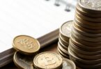 Australian dollar coins and a notebook.