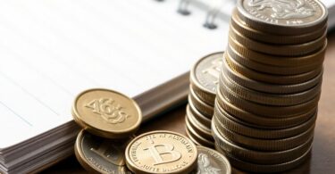 Australian dollar coins and a notebook.