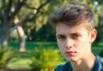 Young person looking thoughtful, Australian setting.