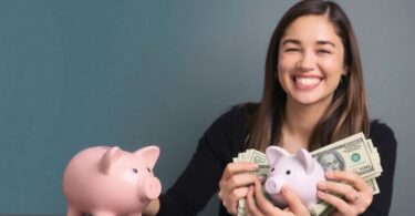 Person happily reviewing money with a balanced budget.