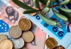 Australian coins and banknotes with a leafy branch.