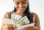 A person happily reviewing money and bills.