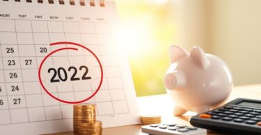 Calendar date circled, coins, piggy bank, calculator, sunlight.