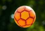 Soccer ball hovering over a grassy field.