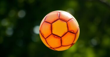 Soccer ball hovering over a grassy field.