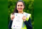 Aussie worker in hi-vis vest with a certificate.