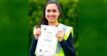 Aussie worker in hi-vis vest with a certificate.