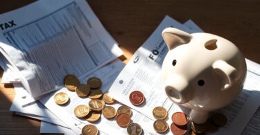 Tax forms and piggy bank.