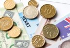 Australian coins and banknotes near a tax document.