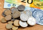 Australian coins and banknotes scattered on a table.