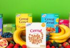Colourful cereal boxes stacked with fresh Australian fruits.