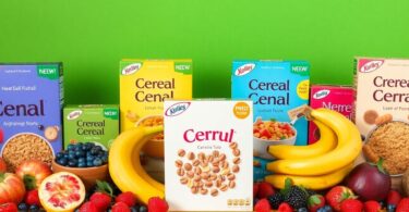 Colourful cereal boxes stacked with fresh Australian fruits.