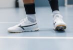 Soccer player in indoor shoes on court.