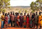 Aboriginal Australians gathered outdoors in native Australian landscape.