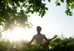 Person meditating in a peaceful green Melbourne garden.