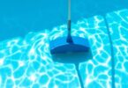 Clean pool with vacuum cleaner underwater.