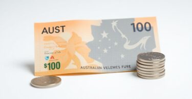 Australian $100 note and coins