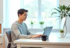 Person working from home at modern desk with laptop