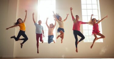 Young dancers leaping joyfully in a sunlit studio.
