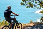 Ebike rider on Australian coastal path, wearing helmet.