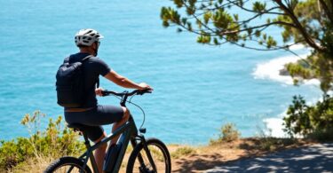 Ebike rider on Australian coastal path, wearing helmet.