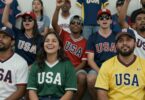 Fans in USA sports clothing celebrating.