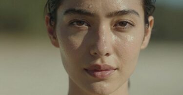 Woman with radiant, healthy skin glowing in natural light.