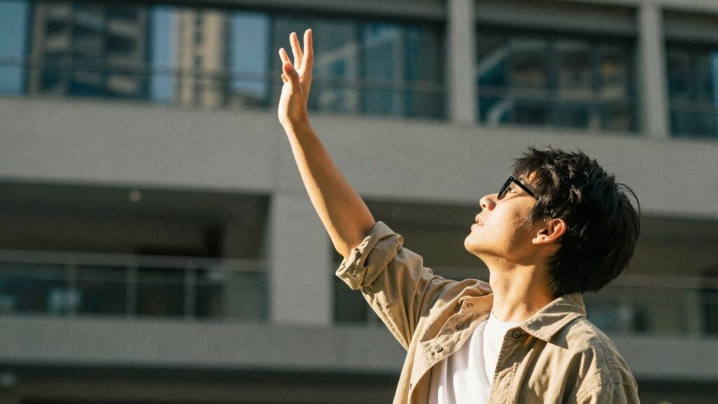 Person reaching for opportunity with NSW government grants.