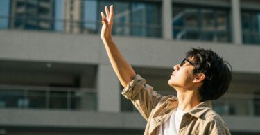 Person reaching for opportunity with NSW government grants.