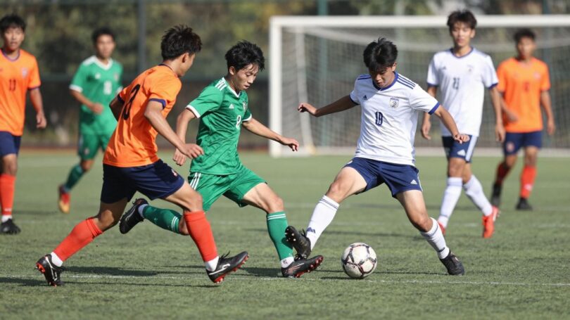 Ringwood Soccer Club players in action on a green field.