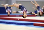 Young gymnasts leaping and tumbling with energy.