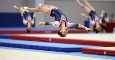 Young gymnasts leaping and tumbling with energy.
