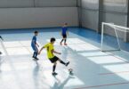 Indoor soccer pitch with players in action