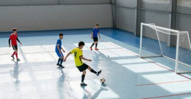 Indoor soccer pitch with players in action