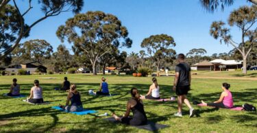People enjoying outdoor activities in a sunny Australian landscape.