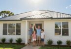 Family outside new Queensland home, holding keys.