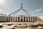 Australian Parliament House with golden coins overlay.