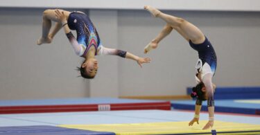 Gymnasts performing flips and tumbles at Gladesville Gymnastics Club.