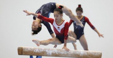 Gymnast mid-air during a floor routine.