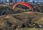 Paraglider flying over Canberra hills