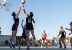Aspley Devils netball players in action on court.