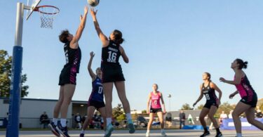 Aspley Devils netball players in action on court.