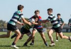 Young rugby league players in action on a field.