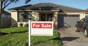 Australian house for sale with green lawn.