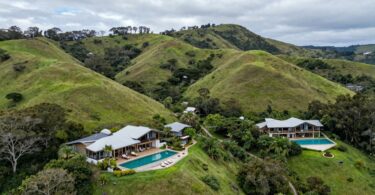 Gaia Retreat Byron Bay aerial view, tranquil pools, lush hills.