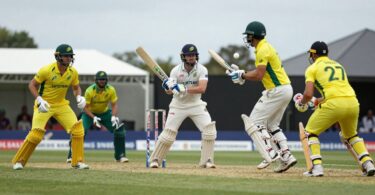 Cricket players in action during a match.